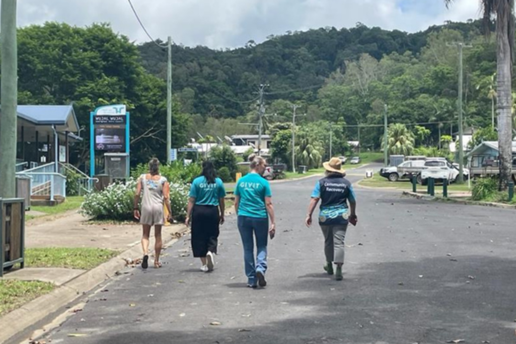 GIVIT Engagement Officers Christina and Temiah walking the streets of Wujal Wujal with a disaster recovery staff member to survey damage.